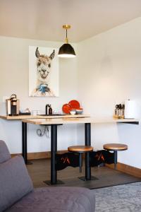 a table in a room with a dog picture on the wall at Cuchara Lokal in La Veta