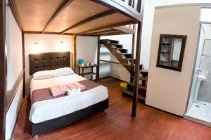 a bedroom with a large bed and a staircase at Cusco'sHome 3 in Cusco