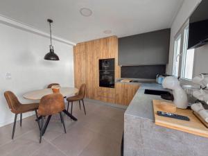 a kitchen with a table and chairs in a room at Alma do Mar - Alma Nossa in Montijo +16 photos
