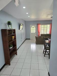 a living room with a couch and a table at The Gardens in Kingston