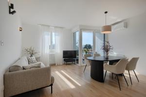 a living room with a couch and a table and chairs at Fiorea Apartment - Pula City Center With Private Garage Parking in Pula