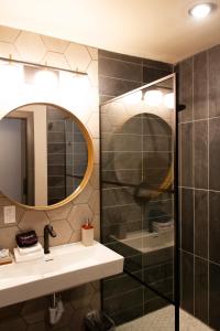 a bathroom with a shower and a sink and a mirror at Cuchara Lokal in La Veta