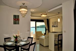 a dining room and living room with a table and chairs at Shine residence in Budva