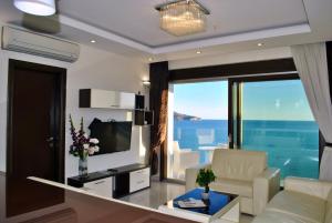 a living room with a view of the ocean at Shine residence in Budva