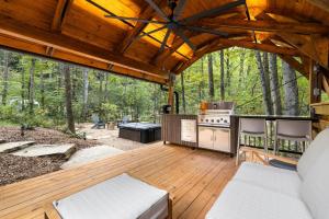a screened in porch with a stove and a grill at Luxury Airstream w hot tub, king bed, & grill in Pisgah Forest