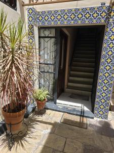 an entrance to a house with potted plants and a door at Espacio Verde in Salta