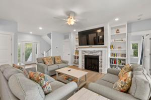 a living room with two couches and a fireplace at Wax Turtle in Southern Shores