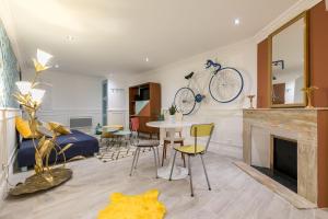 a living room with a bike hanging on the wall at Les Deux Clefs in Mont-de-Marsan