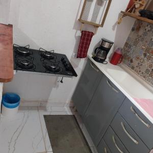 a kitchen with a stove and a counter top at Espaço familiar in Saquarema