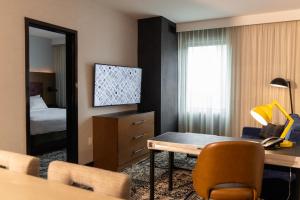 a hotel room with a desk and a bedroom at Hotel Rock Lititz in Lititz