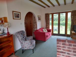 a living room with two chairs and a couch at Nethergate Cottage, Westerclose, Withypool in Withypool