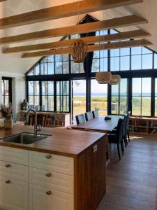 a kitchen with a table and a dining room with a view at Beach Villa With Private Pier In Hou in Odder +32 photos