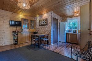 a kitchen with a table and a refrigerator at Dream Forest Cabin -dom w lesie pod Warszawą in Warsaw +48 photos