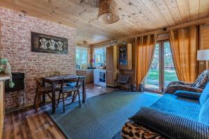 a living room with a couch and a table at Dream Forest Cabin -dom w lesie pod Warszawą in Warsaw