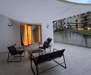 a group of chairs and a table on a patio at Chalet La coccola di Lulù in Molina di Ledro