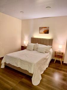 a bedroom with a large bed with two night stands at Amazonía Luxury in Florencia