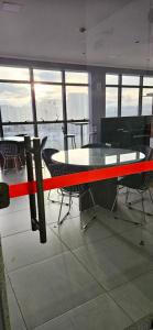 a table and chairs in a room with a red ribbon at Apê Panoramic Águas Claras e Ministérios in Brasília +38 photos