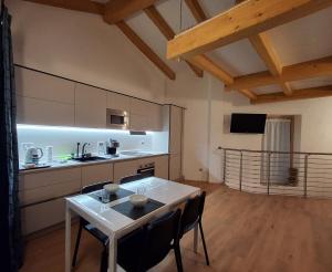 a kitchen with a table and chairs in a room at Chalet La coccola di Lulù in Molina di Ledro