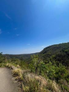 a dirt road on a hill with a blue sky at Fusca Home in Piedade +11 photos