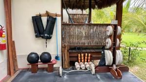 a room with a wall with a bunch of wooden implements at Pousada Lanea Experience in Atins