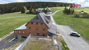 an aerial view of a house with a car parked in front at Apartmán Lidická bouda in Pec pod Sněžkou