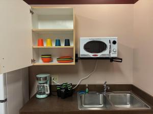 a kitchen with a sink and a microwave at Brewster Hall in Cheney +5 photos