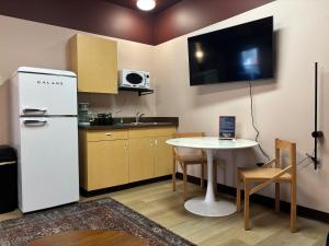 a kitchen with a white refrigerator and a table at Brewster Hall in Cheney