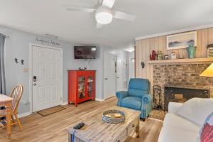 a living room with a couch and a fireplace at Sandpiper Cay 706 in Kitty Hawk