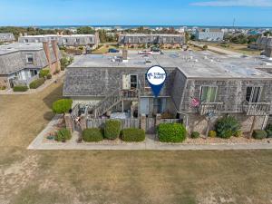 an aerial view of a house with a sign on it at Sandpiper Cay 706 in Kitty Hawk