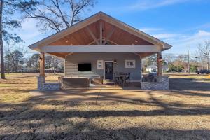 a large pavilion with a roof on a field at The Park House in Batesville