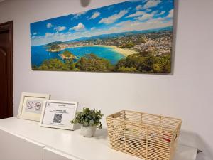 a picture of a beach on a wall at Pensión Santa Clara in San Sebastián