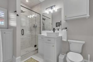 a white bathroom with a shower and a toilet at The Park House in Batesville +21 photos