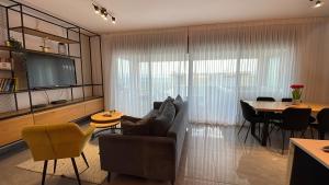 a living room with a couch and a table at סי כנרת- דירות עם בריכה פרטית מבית בלו מגדל in Migdal