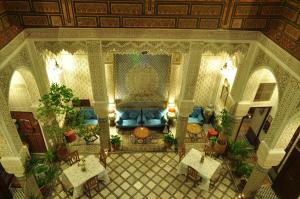 a living room filled with lots of furniture at Riad Sara in Fès