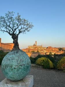 a statue of a tree in front of a building at B&B Siena Le Grondaie in Siena