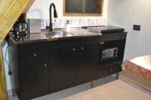 a kitchen with a sink and a counter top at Chalé Pé da Serra - Região de Monte Verde in Camanducaia