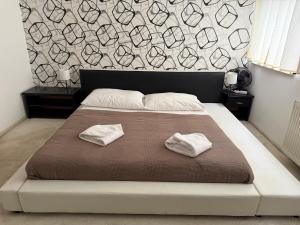 a bedroom with a large bed with two towels on it at Botel Gracia in Bratislava +136 photos