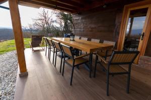 a wooden table and chairs on a wooden deck at Timber Home in Veliko Trgovišće