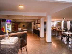 a restaurant with a bar with tables and chairs at Hotel do Vale in Campina Grande