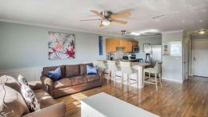 a living room with a couch and a table at Canal Place 206 in Destin
