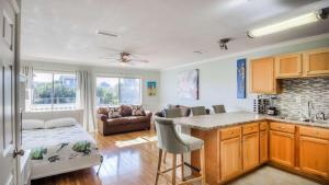 a kitchen and living room with a couch and a table at Canal Place 206 in Destin +12 photos
