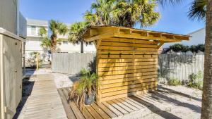 a wooden shed with a roof on a wooden deck at Canal Place 206 in Destin