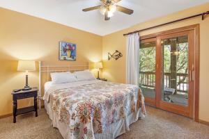 a bedroom with a bed and a ceiling fan at Dragonfly in Southern Shores +37 photos