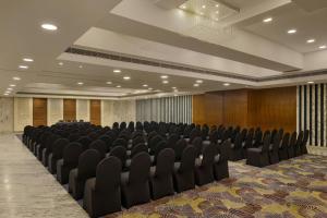 a room with rows of chairs in a hall at The Fern Residency Ahmedabad, Subhash Bridge, Series by Marriott in Ahmedabad