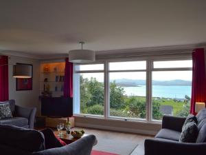 a living room with a large window with a view at Morlich in Gairloch