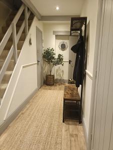 a hallway with a stairway with a door and a table at Cozy 3bed Cottage near Harrogate & Yorkshire Dales in Darley