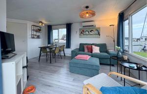 a living room with a couch and a table at Chalet in Breukelen
