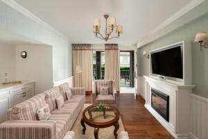 a living room with a couch and a fireplace at The Fern Brentwood Resort, Mussoorie, Series by Marriott in Mussoorie