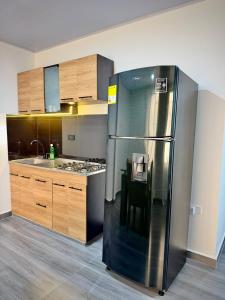 a kitchen with a stainless steel refrigerator at Amazon Luxury Loft 201 in Florencia