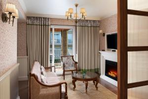a living room with a fireplace and a tv at The Fern Brentwood Resort, Mussoorie, Series by Marriott in Mussoorie